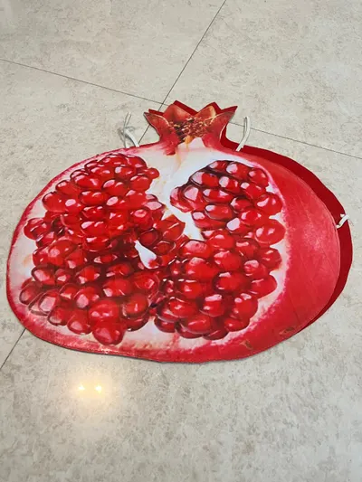 Pomegranate costume board laid flat showing the aril print, white pith and calyx crown
