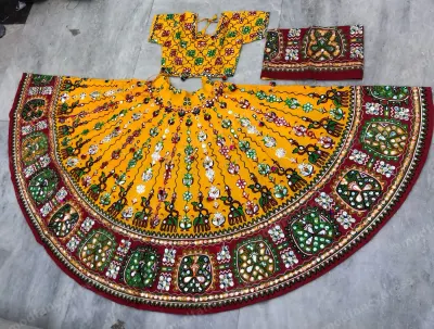 Yellow garba chaniya choli laid flat — full-circle mirror-work lehenga with maroon elephant-motif border, matching choli and dupatta